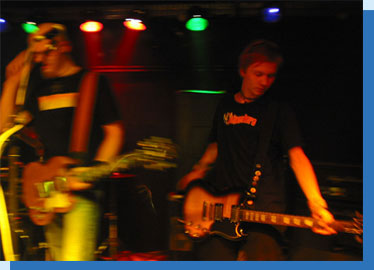 Two of the Silver Fire band members Silver Fire band members playing on a stage